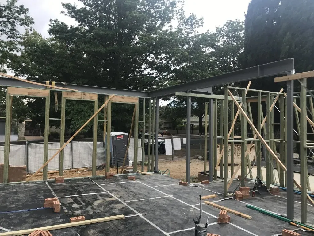 Metal scaffolding supported by wooden blocks