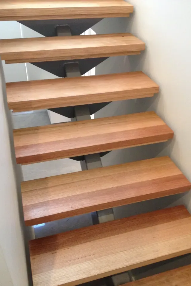 A staircase with wooden steps and a metal frame