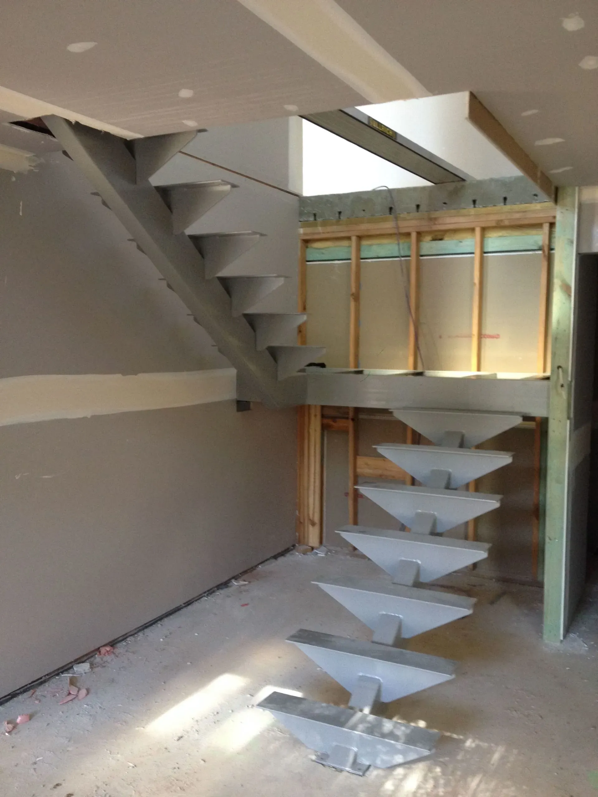 An empty room with a staircase in the middle of it