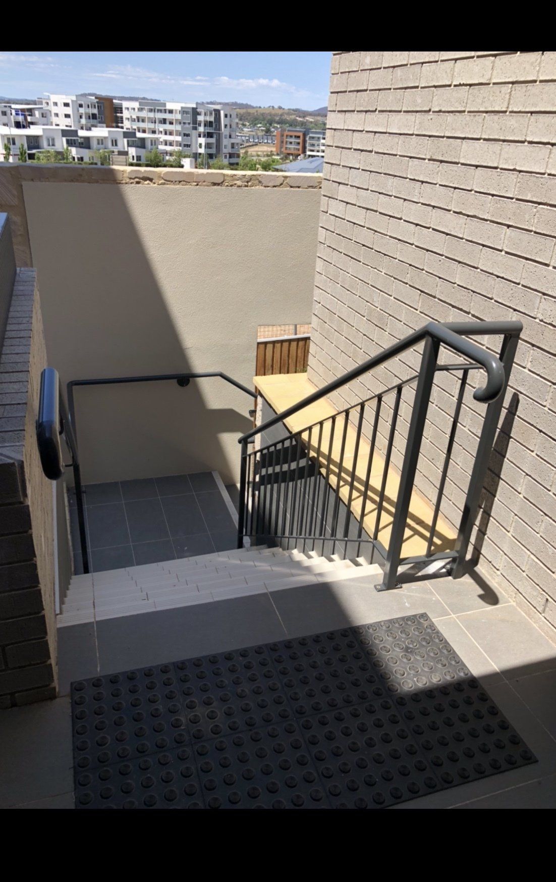 A set of stairs leading up to a building with a railing.