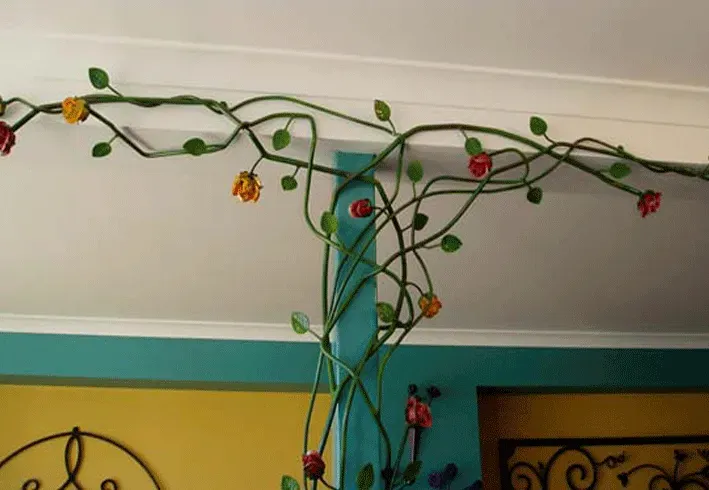 A ceiling with flowers and leaves hanging from it