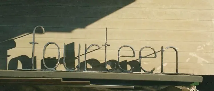 A sign that says fourteen is sitting on a table