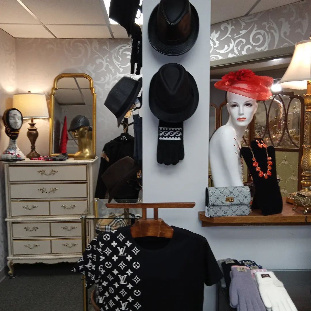 Interior shop display with hats, clothes, and mannequins.