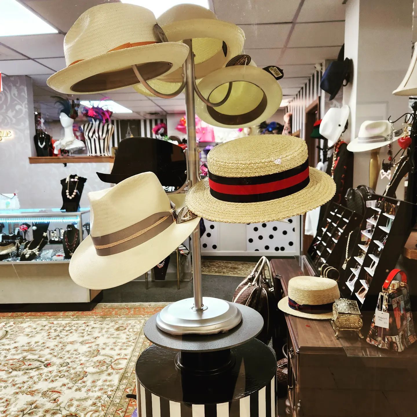 Display of hats in a shop, featuring a multi-level hat stand with various styles.