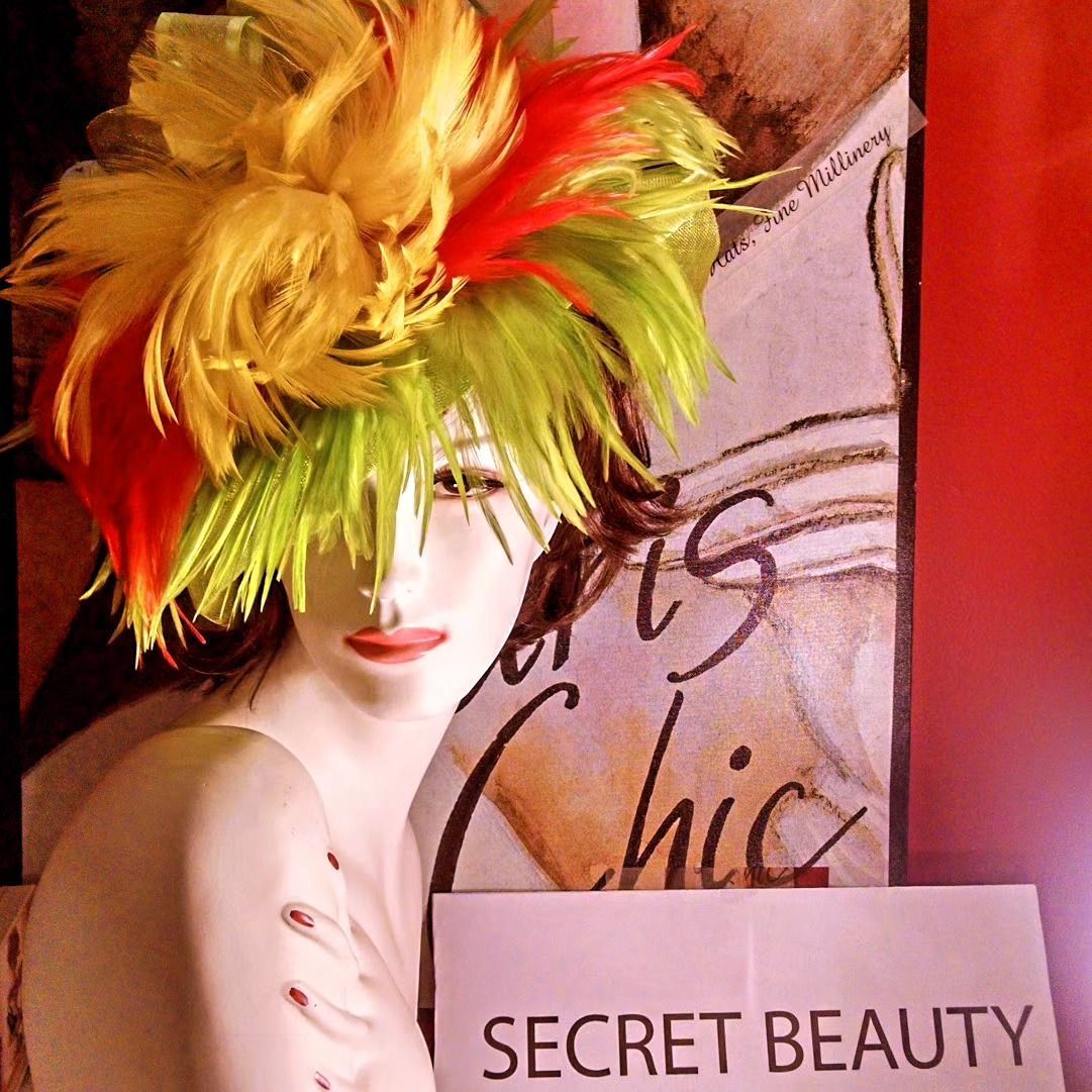 Mannequin with multi-colored hair and red lips holding sign that reads, 