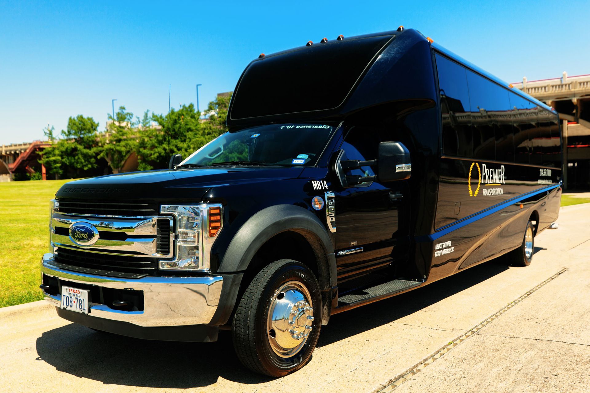 premier's black shuttle bus is parked on the side of the road .