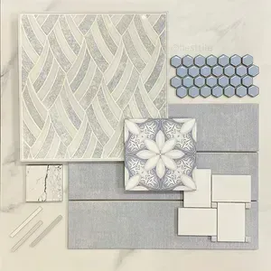 Assorted pale gray and white tile samples and decorative mosaic patterns arranged on a flat surface
