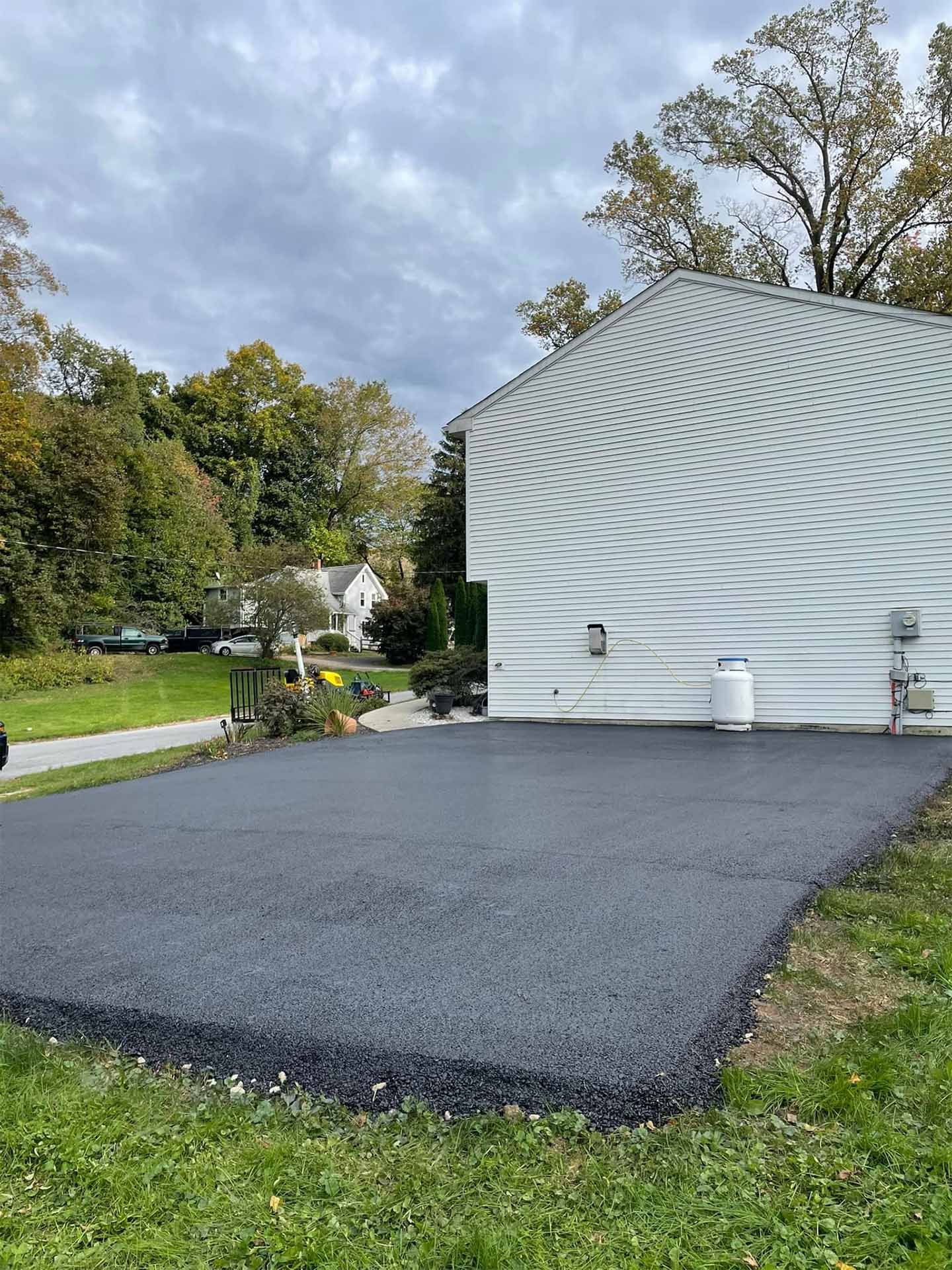 A large white house with a black driveway in front of it