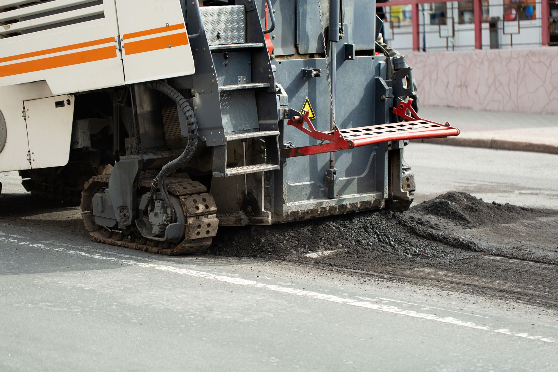 A large machine is working on the side of a road