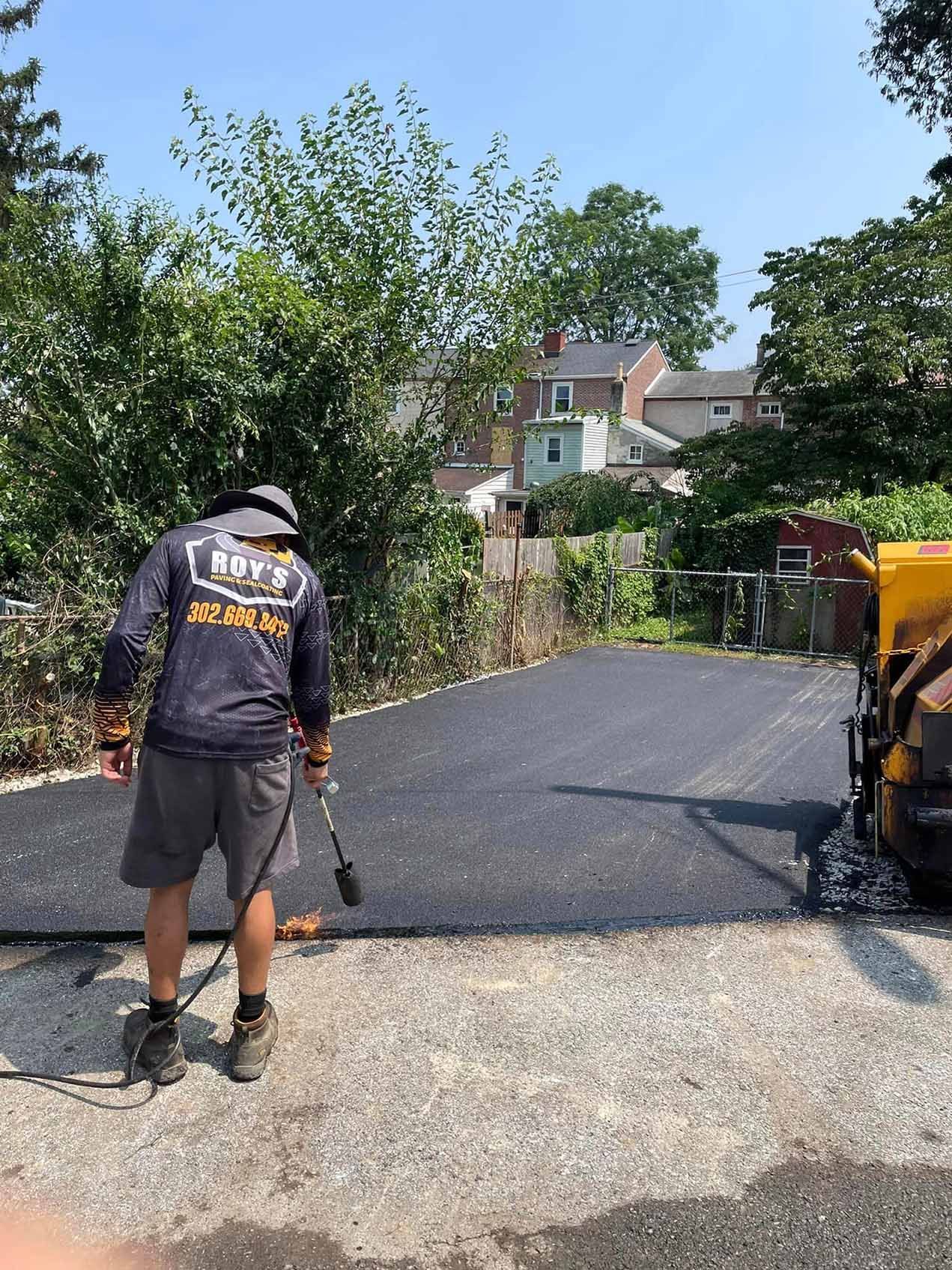 A man is standing on the side of a road holding a torch