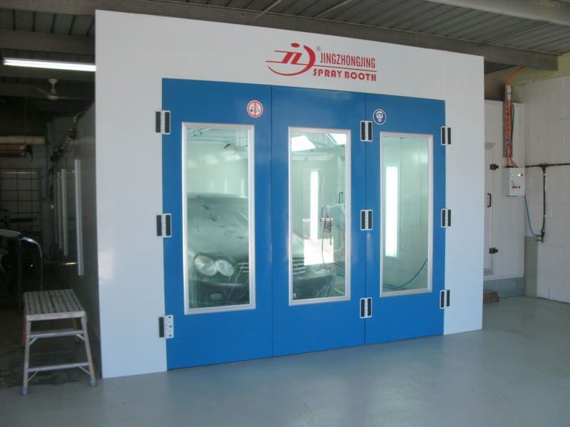 Black car in closed spray booth