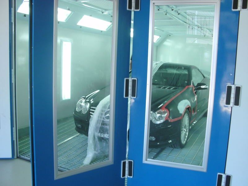 Black car in spray booth