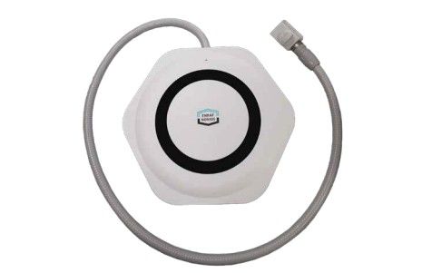 White hexagonal device with black ring and attached gray hose.