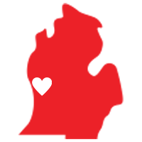 A red map of michigan with a white heart in the middle.