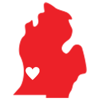 A red map of michigan with a white heart in the middle.