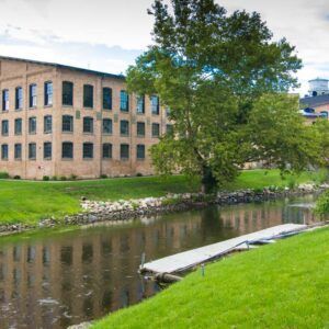 A large building with a river in front of it