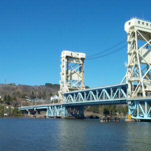 A bridge over a body of water with a blue sky in the background