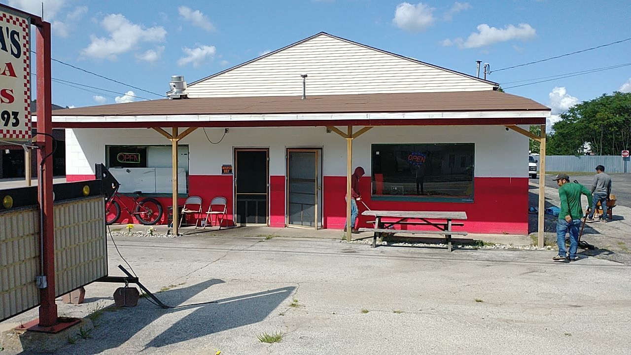 A red and white building with a sign that says ' a ' on it
