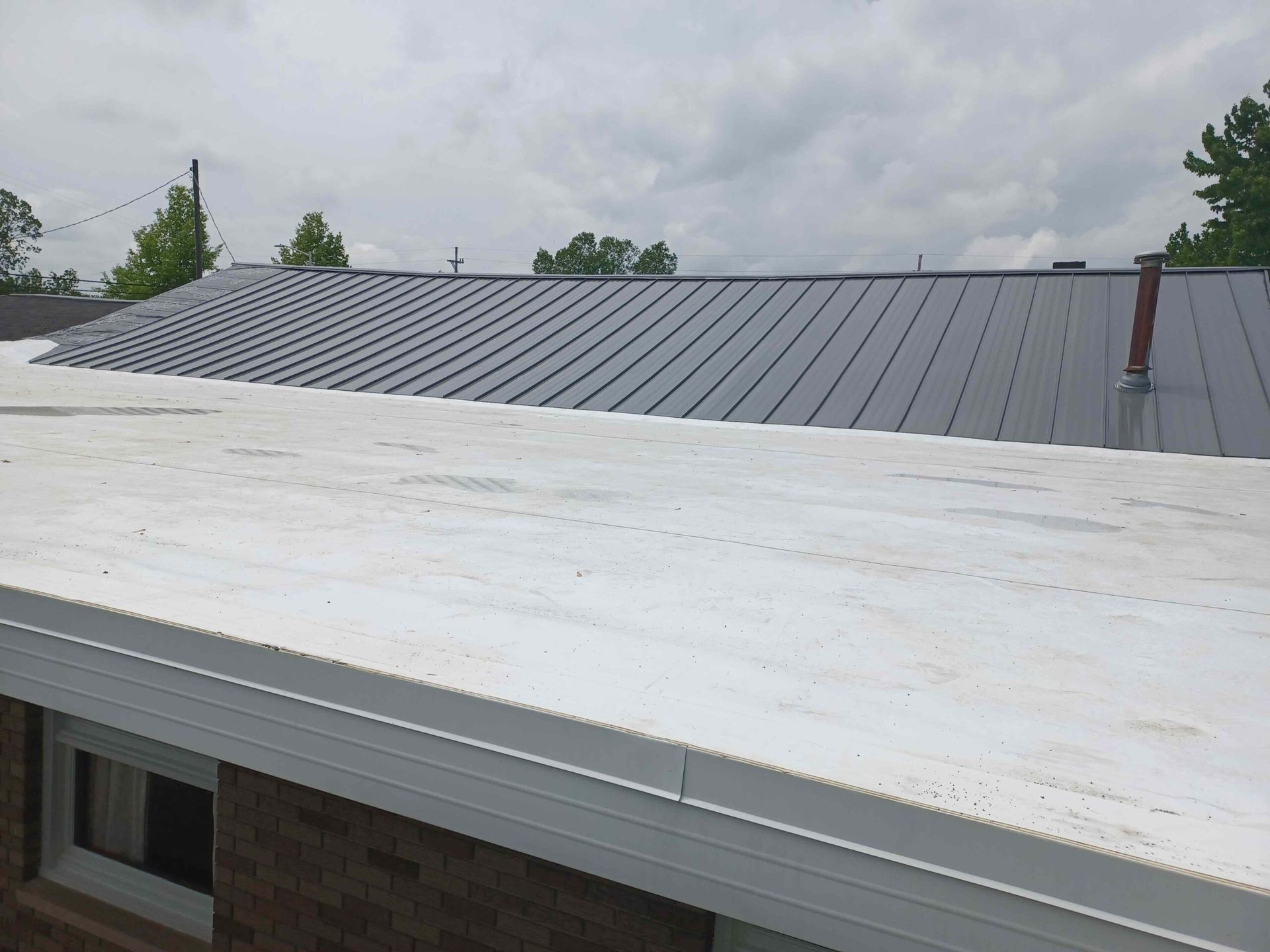 A house with a white roof and a black roof