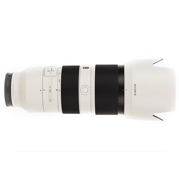 A white and black camera lens with a hood on a white background.