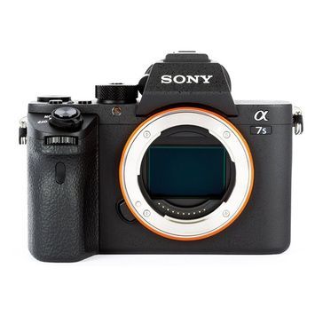 A sony camera is sitting on a white surface.