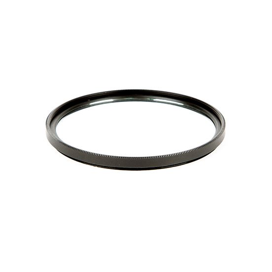 A black ring is sitting on a white surface.