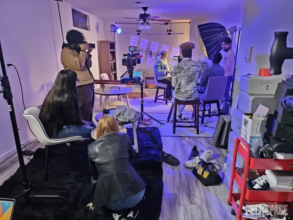 A group of people are sitting in a living room.