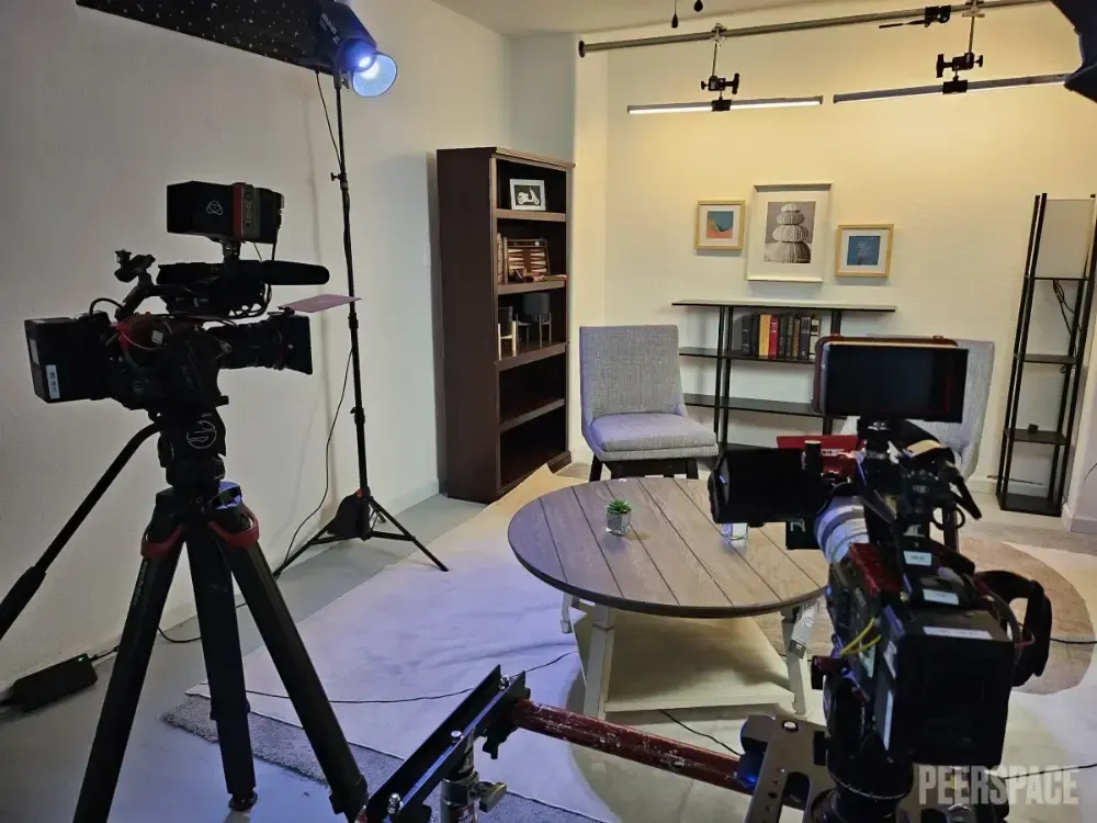 A camera is sitting on a tripod in a living room