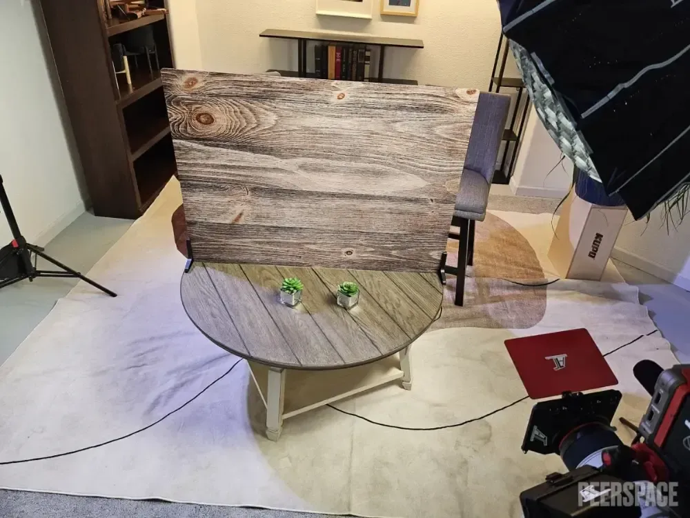 A room with a wooden table and a painting on the wall