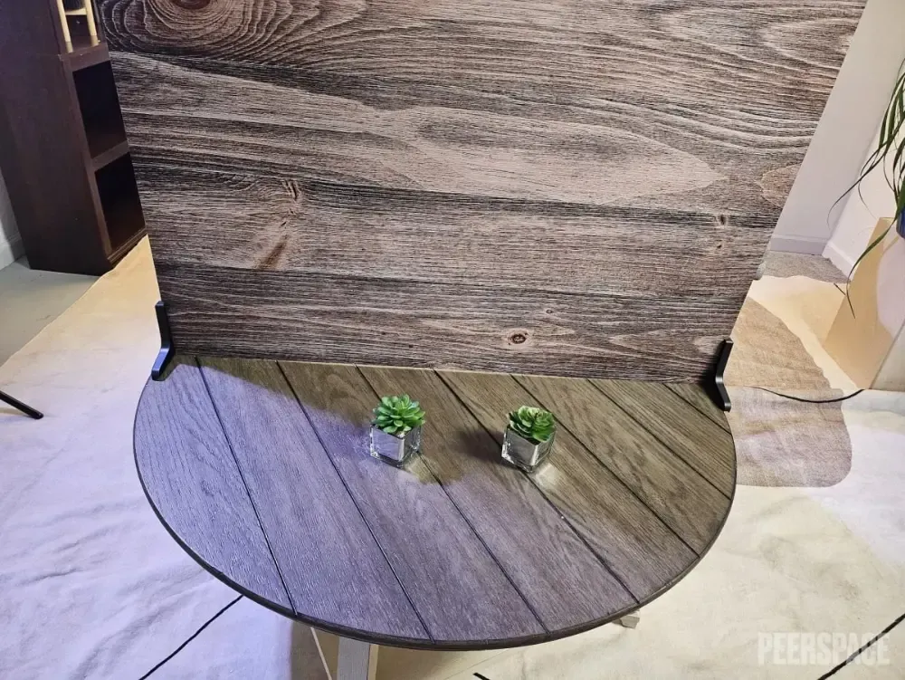 A wooden table with two potted plants on it