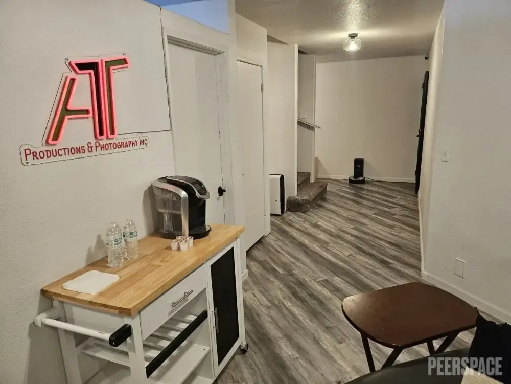 A room with a wooden table and a coffee maker on it.