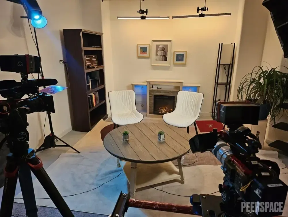 A camera is in a living room with a table and chairs