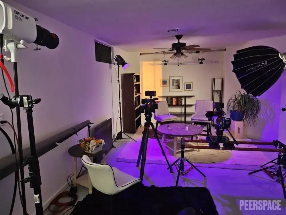 A room with a lot of cameras and lights and the word peerspace on the bottom