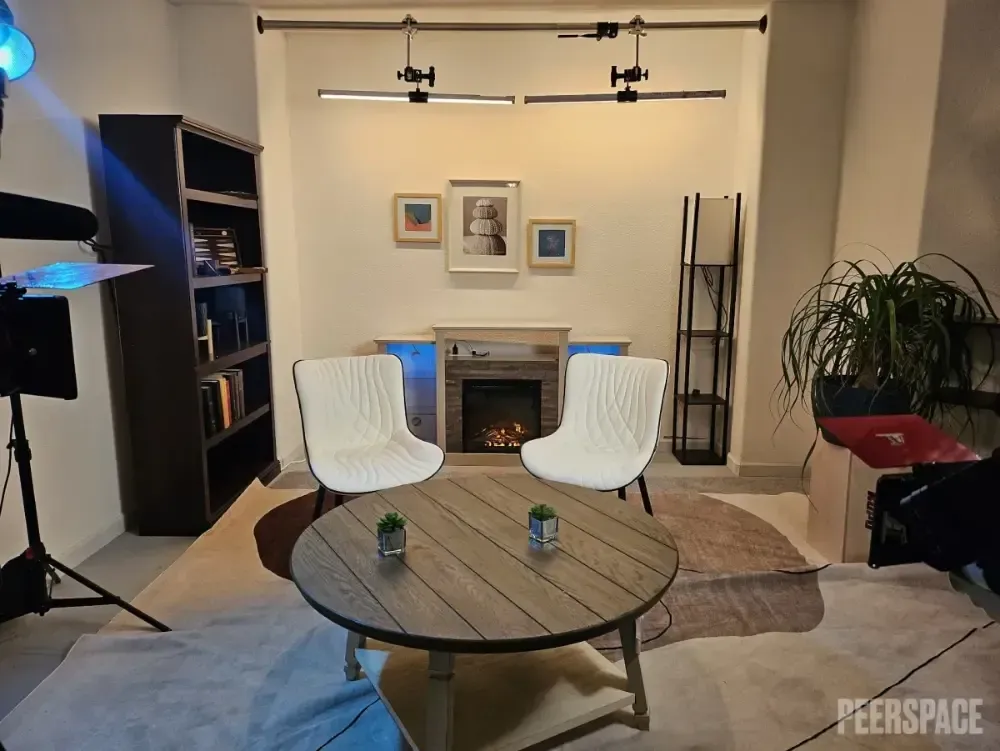 A living room with a fireplace and two chairs