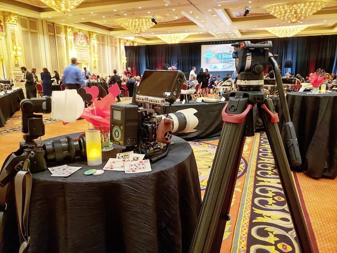 A camera is sitting on top of a table in a large room.