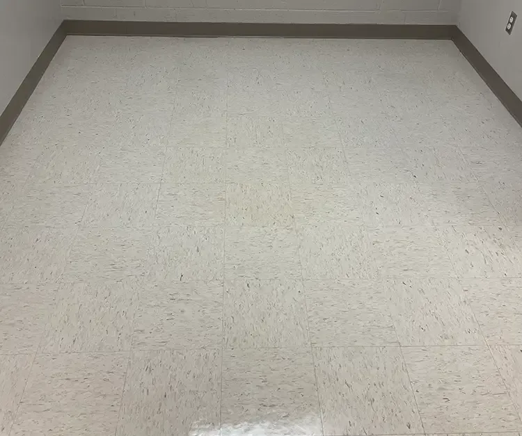 A room with a white tile floor and a brown trim.