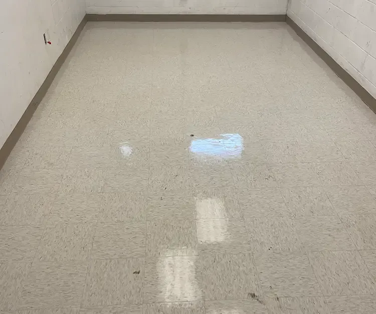 A room with a white tile floor and a white wall.