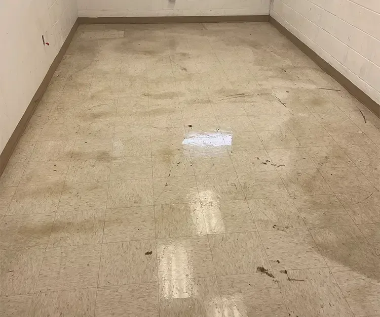 A room with a tiled floor and a white wall.