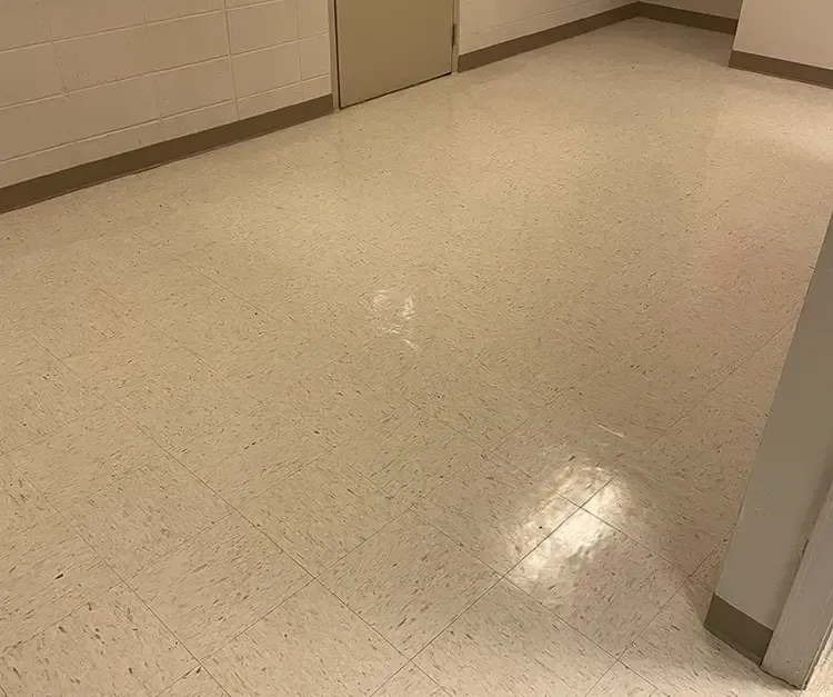 A room with a white tile floor and a door.