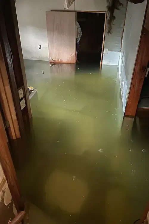 A flooded room with a lot of water on the floor.