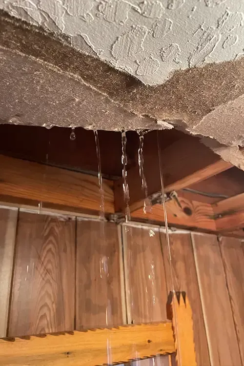 Water is dripping from the ceiling of a room.