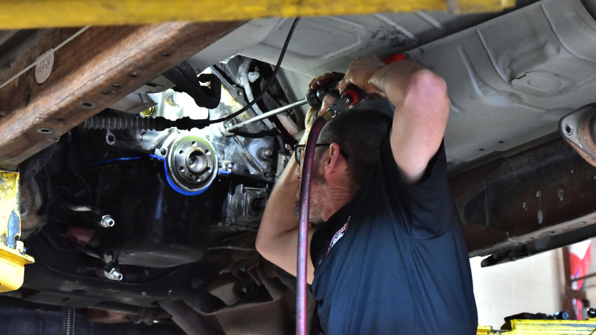 Technician performing a freeze plug replacement during a coolant leak repair in North Phoenix shop