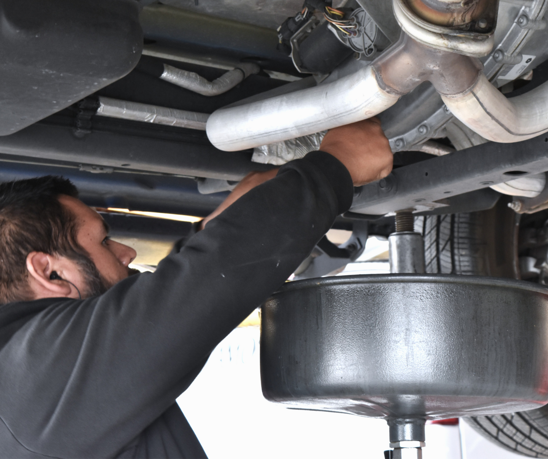 Auto technician performing oil change service at North Phoenix tire and repair shop