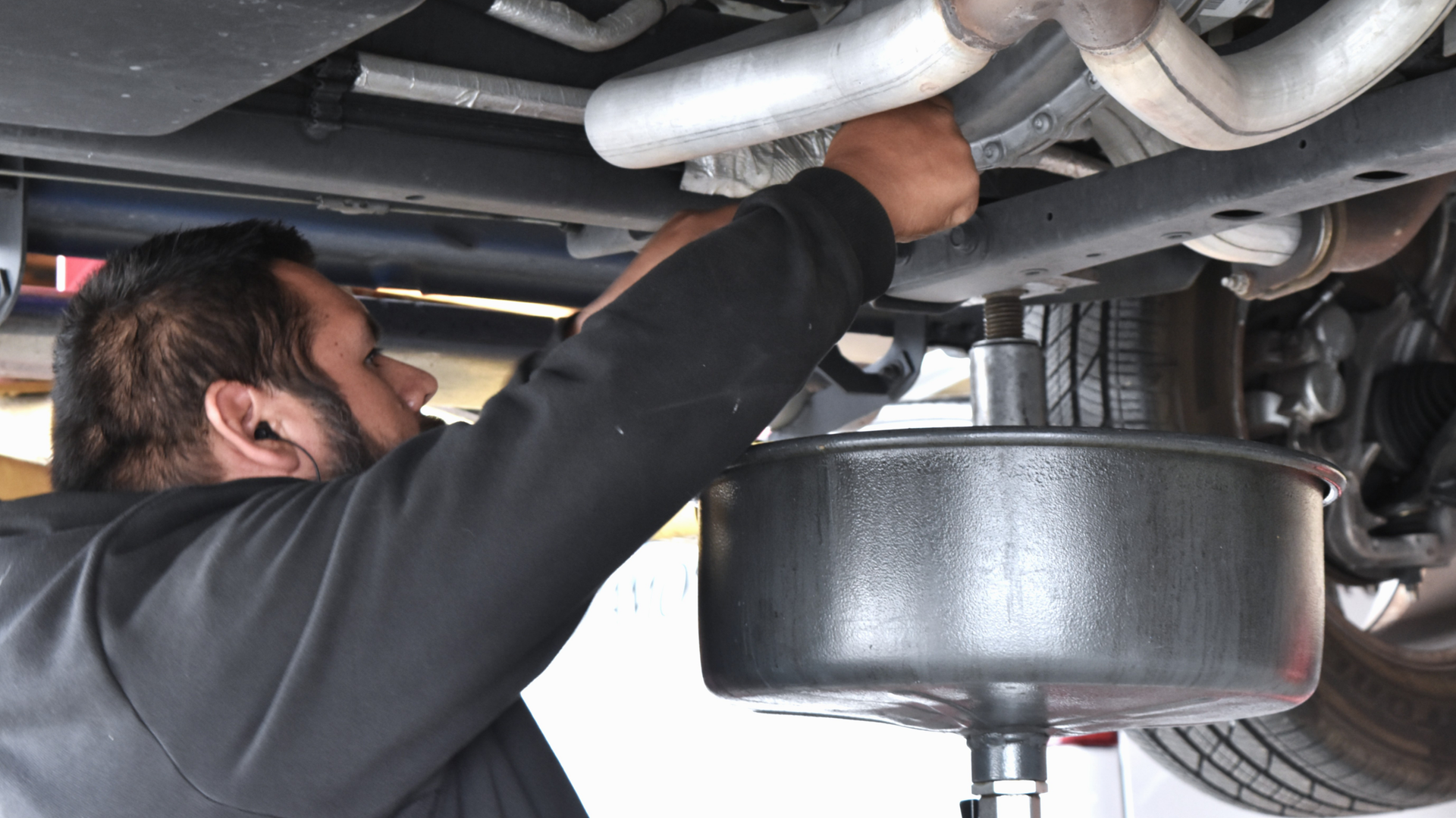 Auto technician performing oil change service at North Phoenix tire and repair shop