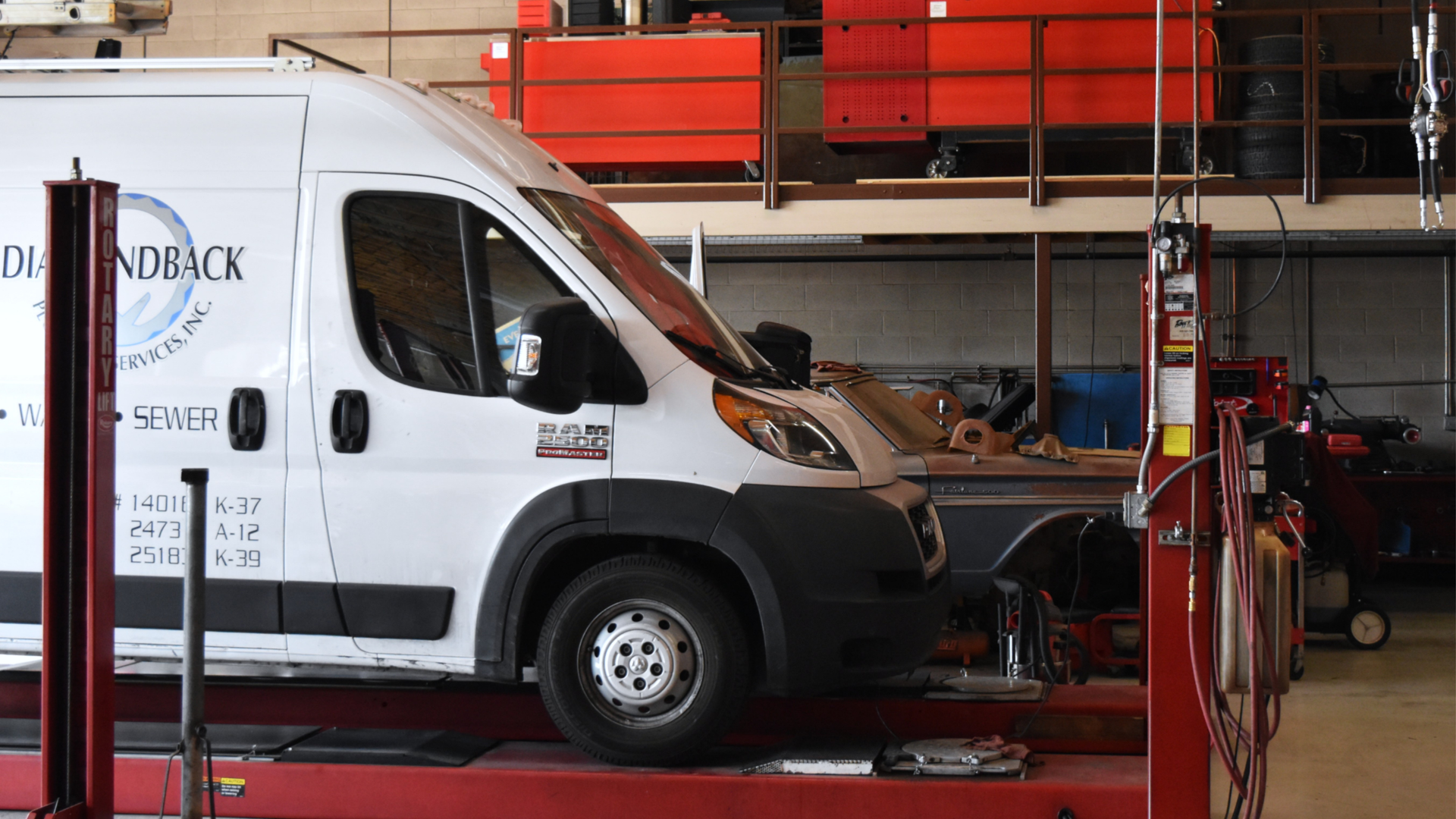 Fleet vehicle on a lift at Precision Tire and Auto Center in North Phoenix for maintenance service