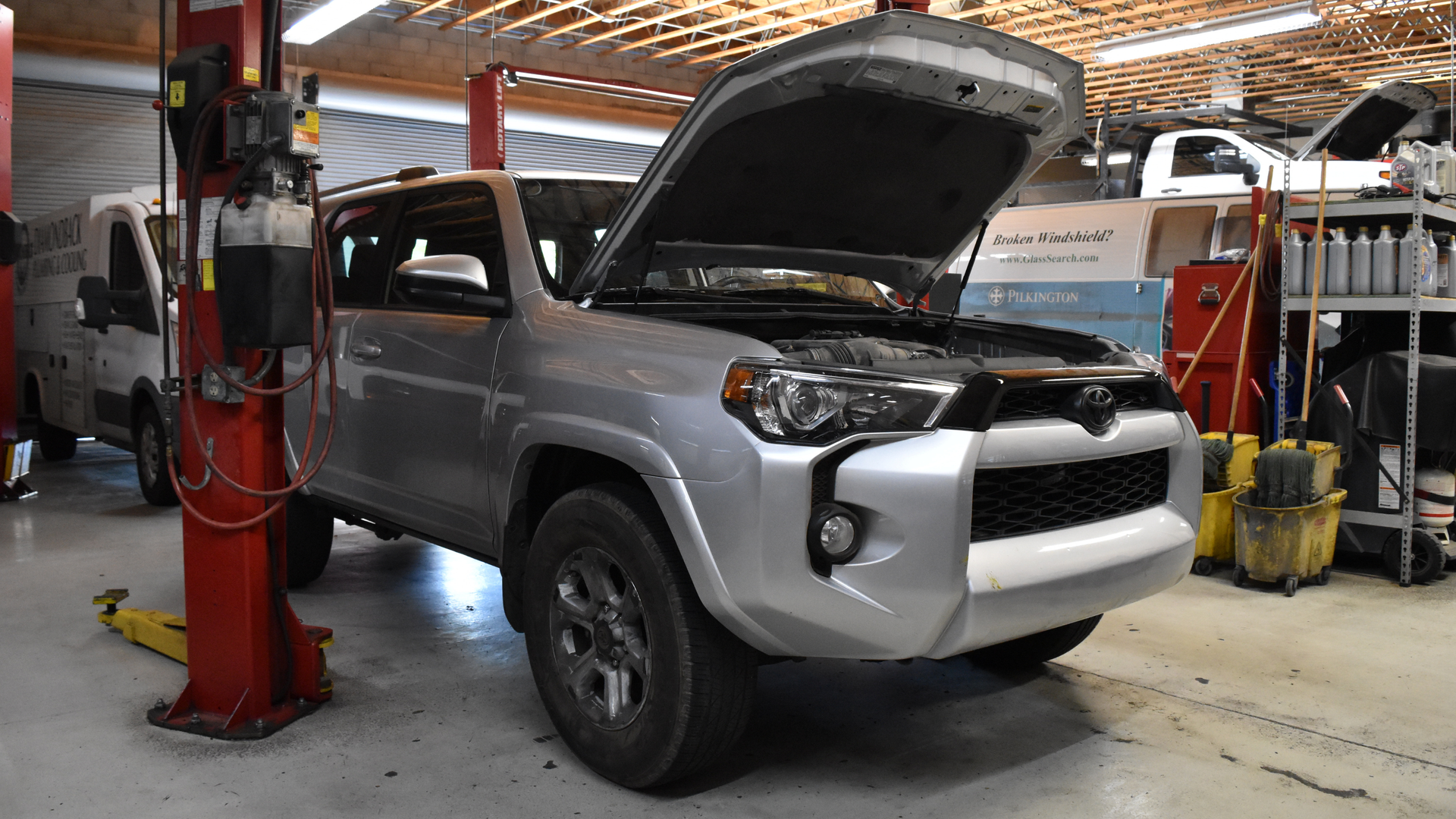 Toyota 4Runner in Phoenix auto shop with hood up fo maintenance at Precision Tire and Auto Center 