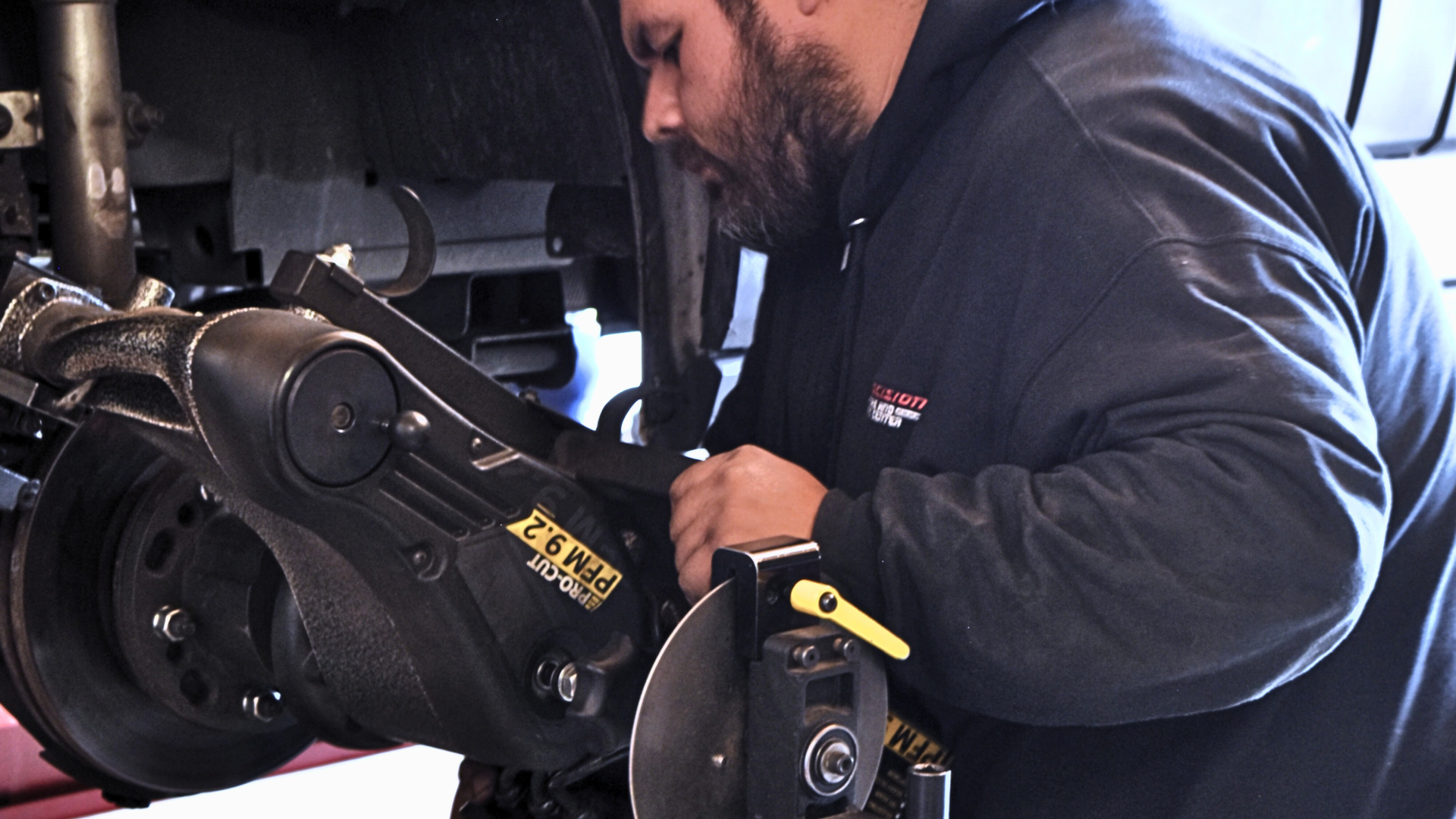 Precision Tire and Auto technician using a brake lathe to resurface rotors during a brake service