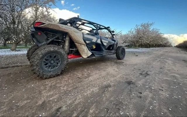 A can am maverick x3r is parked on a dirt road.