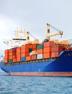 Cargo ship carrying orange and blue shipping containers on blue ocean- Quality Storage Container