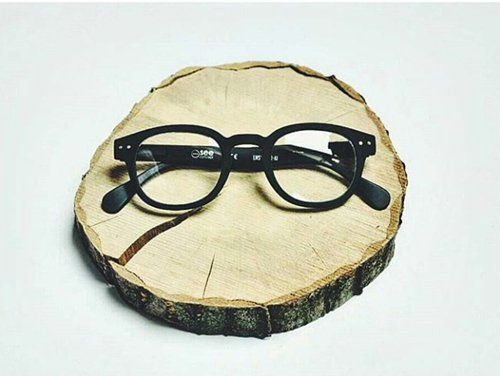 paio di occhiali da vista sopra un pezzo di tronco